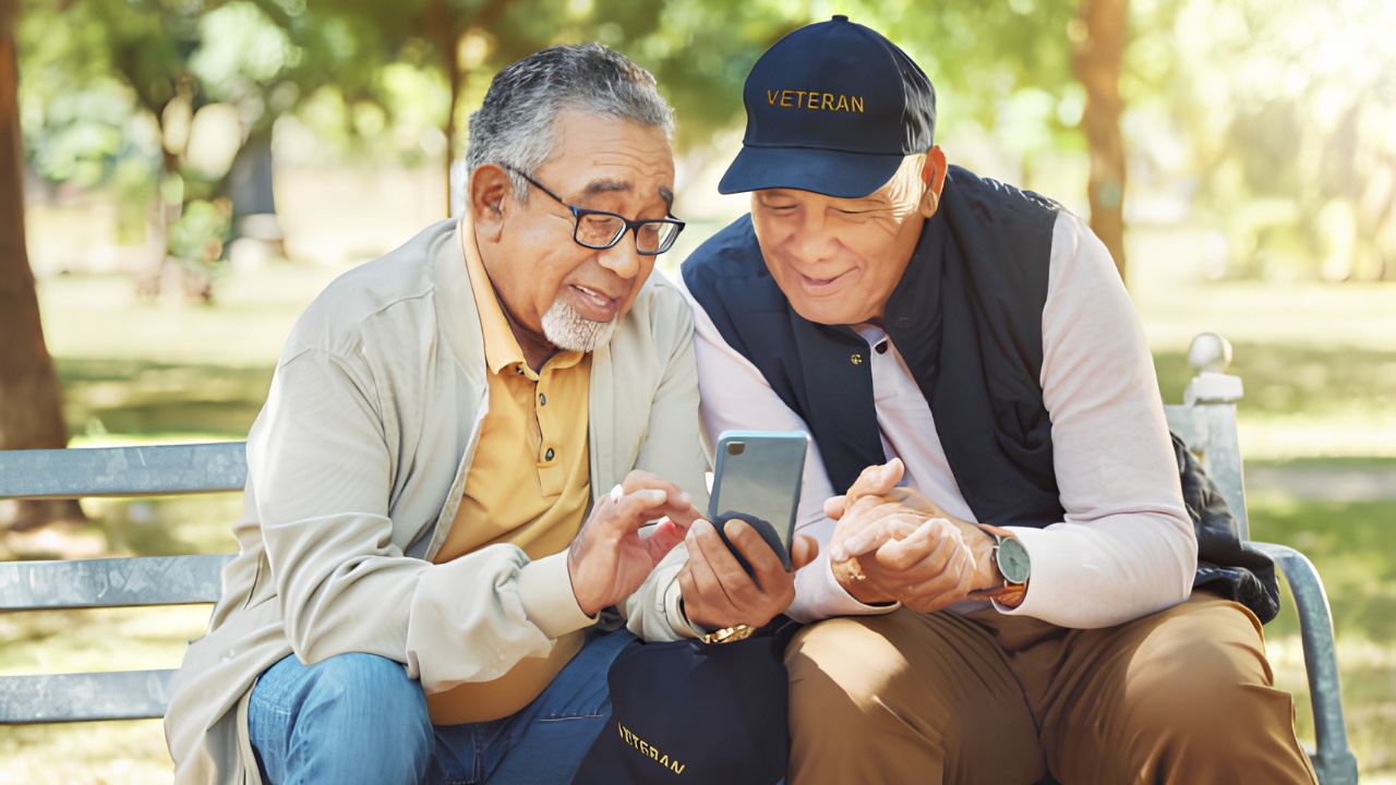A veteran reviewing program information on a phone with a companion